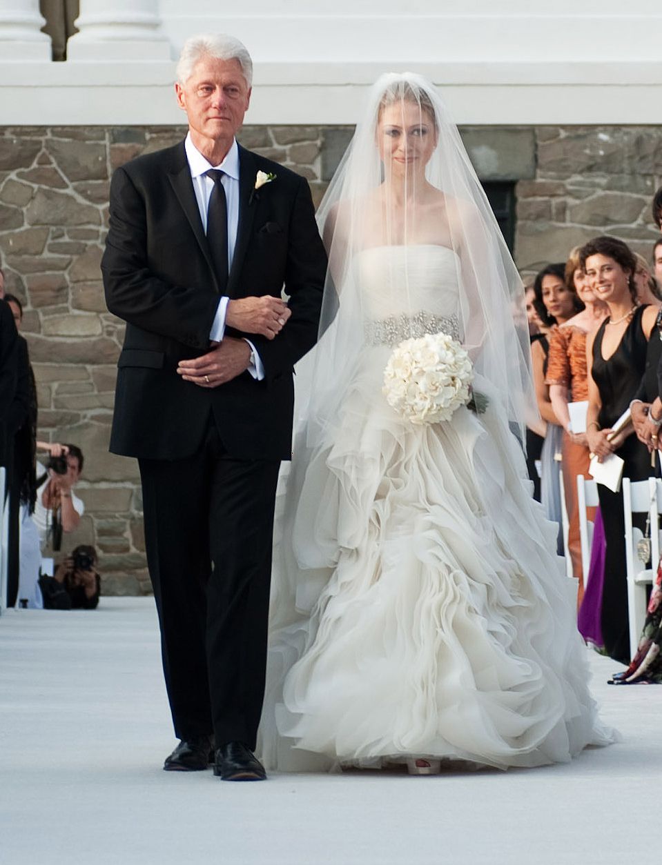 former U.S. President Bill Clinton (L) walks Chelsea Clinton down the aisle during her wedding to Marc Mezvinsky