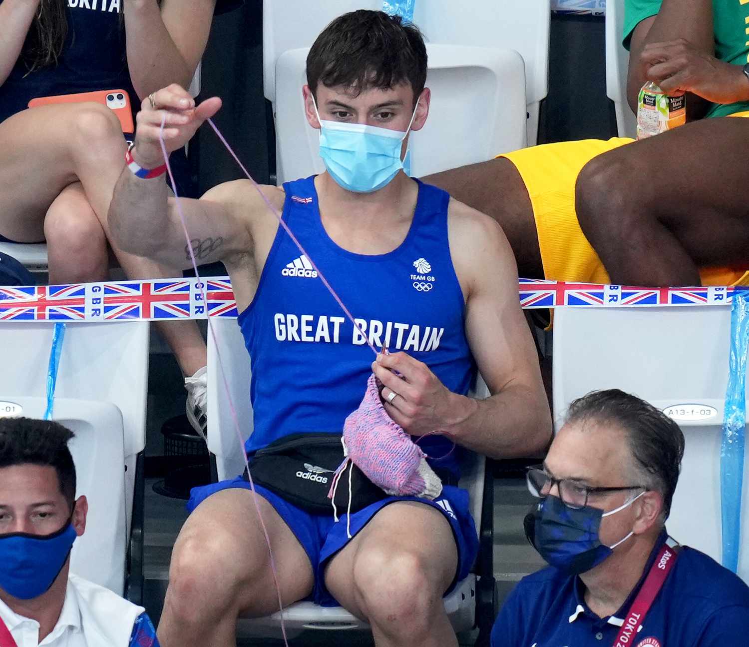 Great Britain's Tom Daley knits in the stands during the Women's 3m Springboard Final at the Tokyo Aquatics Centre on the ninth day of the Tokyo 2020 Olympic Games in Japan. Picture date: Sunday August 1, 2021.
