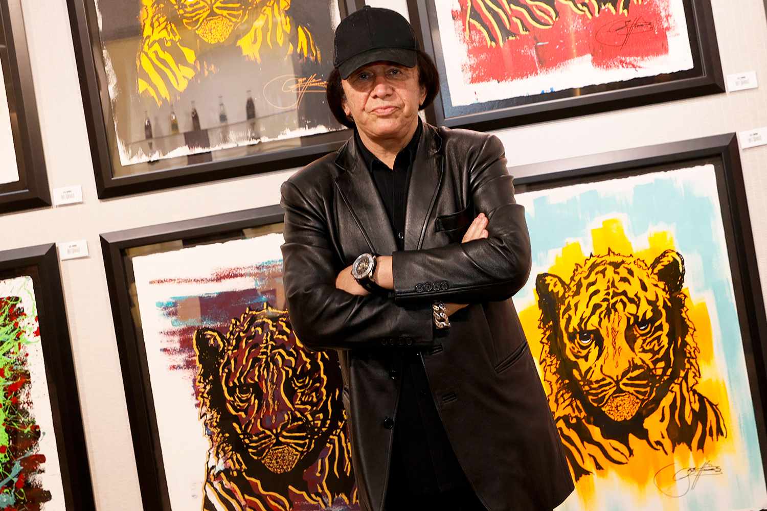 Kiss singer/bassist Gene Simmons poses in front of some of his works at the debut of Gene Simmons ArtWorks at Animazing Gallery at The Venetian Las Vegas on October 21, 2021 in Las Vegas, Nevada.