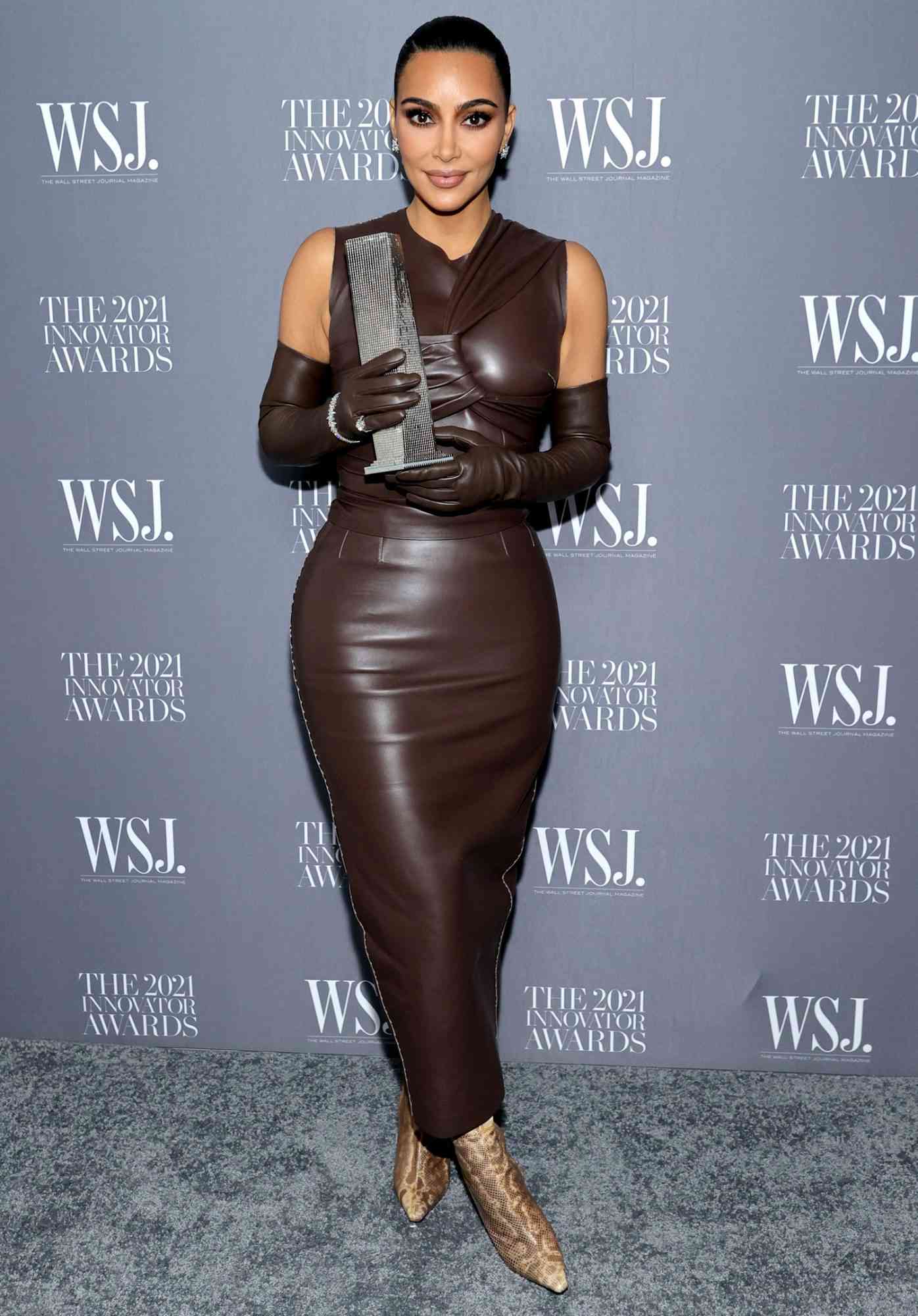 Kim Kardashian West poses with an award during the WSJ. Magazine 2021 Innovator Awards sponsored by Samsung, Harry Winston, and Rémy Martin