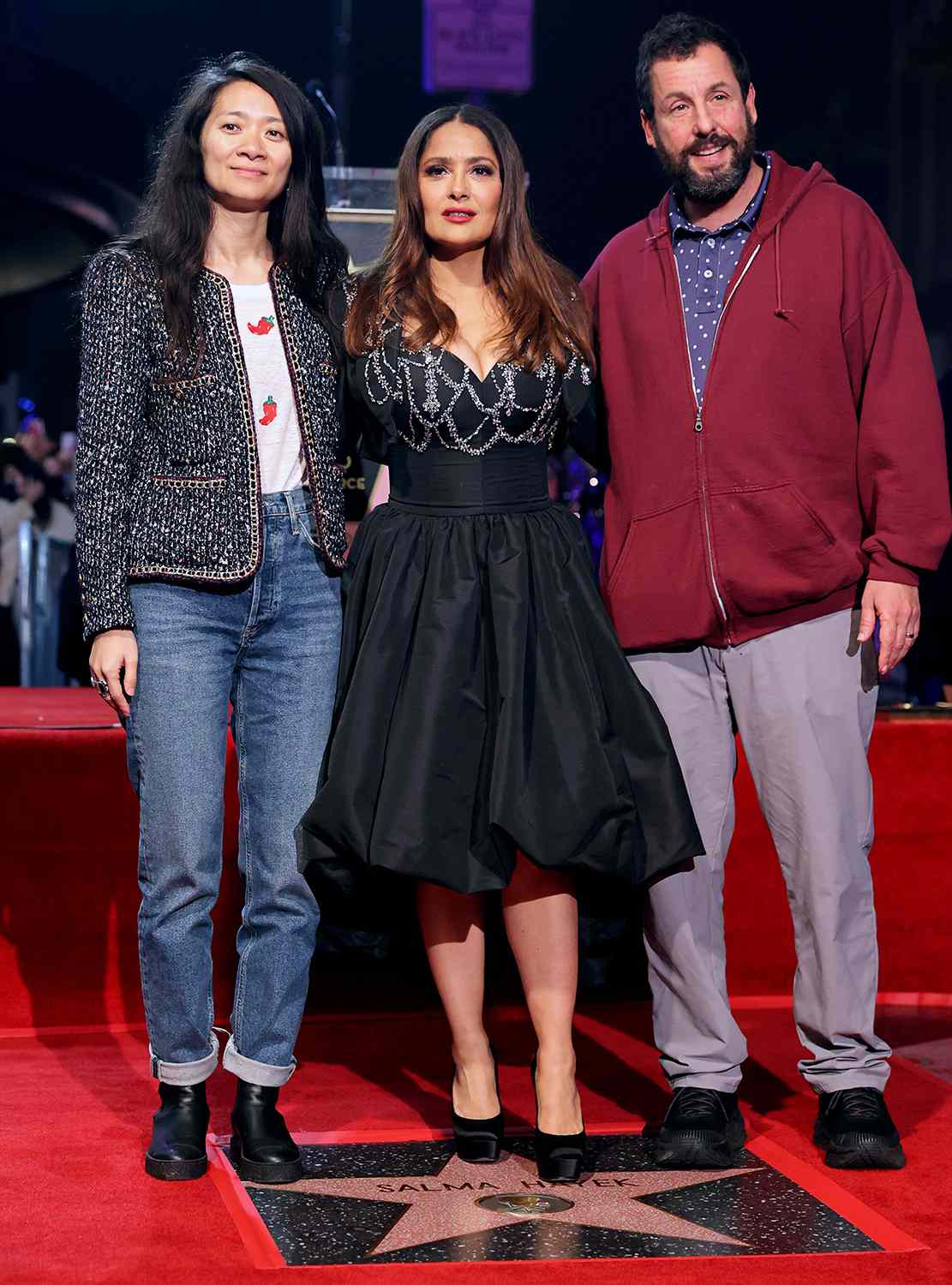 (L-R) Chloé Zhao, Salma Hayek Pinault and Adam Sandler attend the Hollywood Walk of Fame Star Ceremony for Salma Hayek Pinault on November 19, 2021 in Los Angeles, California.