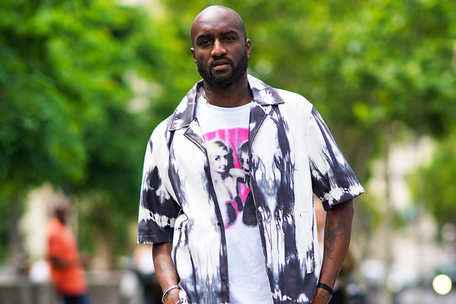Virgil Abloh wears a white t-shirt with a picture print, a tie and dye black and white shirt, outside Heron Preston, during Paris Fashion Week - Menswear Spring/Summer 2020, on June 18, 2019 in Paris, France.