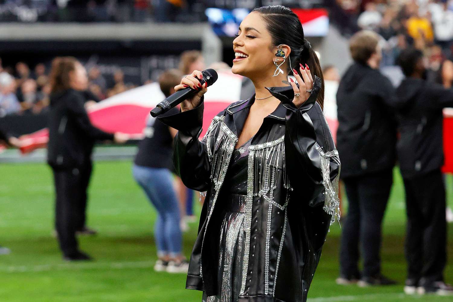 LAS VEGAS, NEVADA - DECEMBER 05: Actress/singer Vanessa Hudgens performs the American national anthem before a game between the Washington Football Team and the Las Vegas Raiders at Allegiant Stadium on December 5, 2021 in Las Vegas, Nevada. The Washington Football Team defeated the Raiders 17-15. (Photo by Ethan Miller/Getty Images)