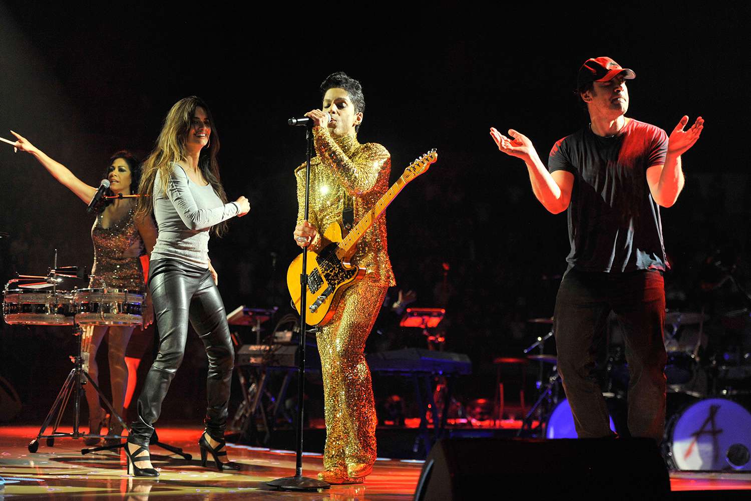 Penelope Cruz and Javier Bardem dance on stage while Prince performs