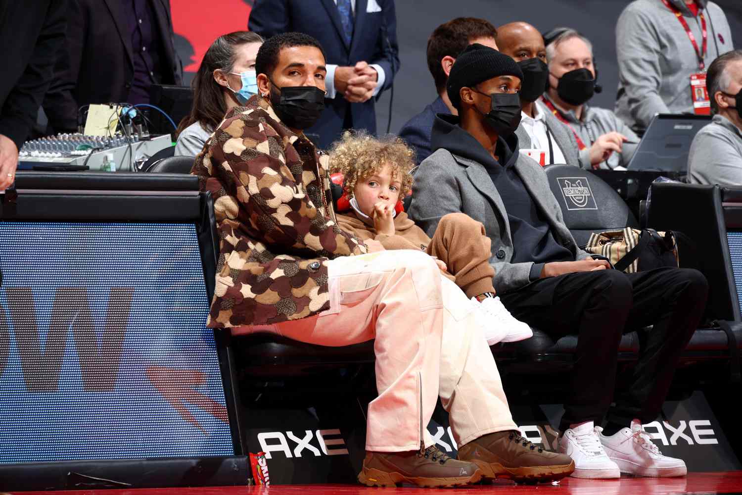 Drake, his son Adonis, and DJ Future the Prince attend the Chicago Bulls v Toronto Raptors game
