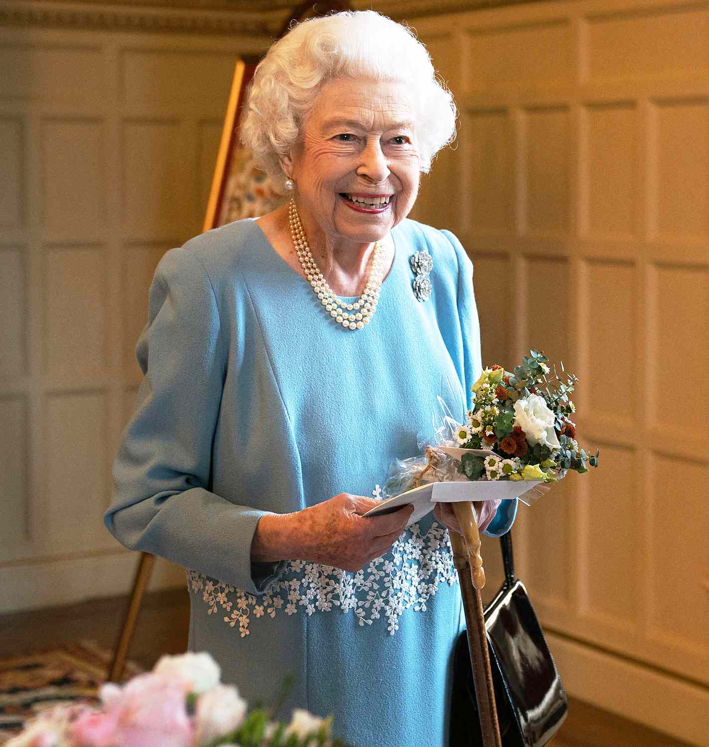 Britain's Queen Elizabeth II talks to members of the West Norfolk Befriending Society as she celebrates the start of the Platinum Jubilee at a reception in the Ballroom of Sandringham House, the Queen's Norfolk residence on February 5, 2022.