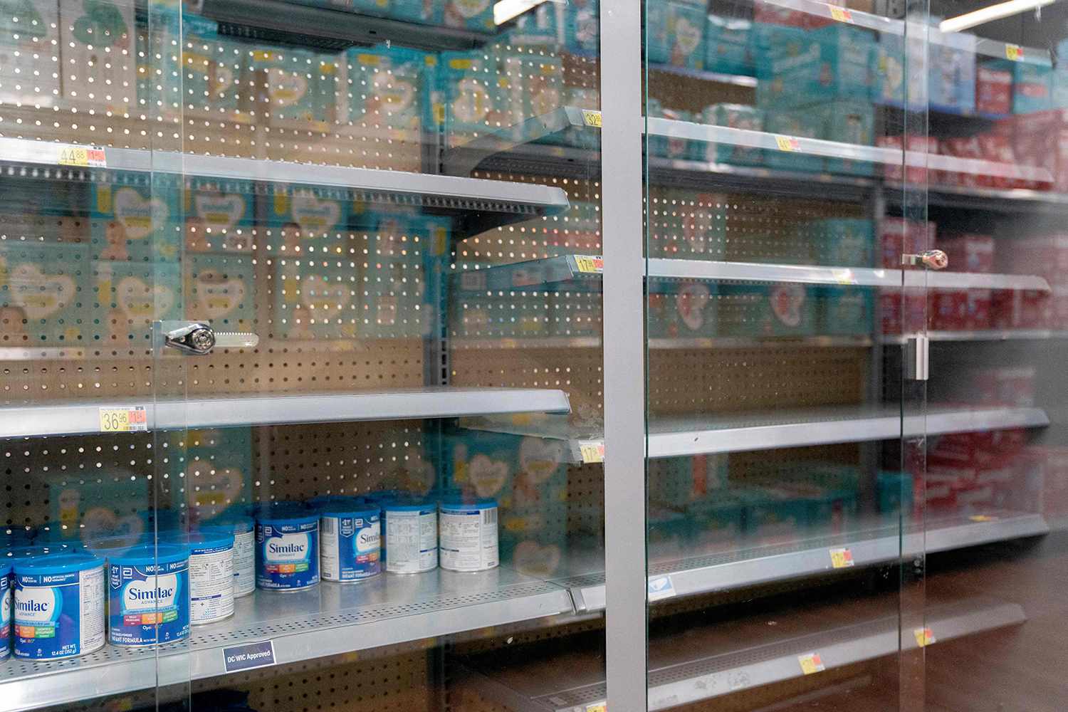 Grocery store shelves where baby formula is typically stocked are locked and nearly empty in Washington, DC, on May 11, 2022. - It's a parent's worst nightmare. The United States is in the grip of a severe shortage of baby formula -- with a mass product recall aggravating pandemic supply chain woes -- sending families on sometimes desperate hunts for the vital supplies. And it's been going on for months, according to Sara Khan, the mother of three children ages 10 years, seven years and six months.