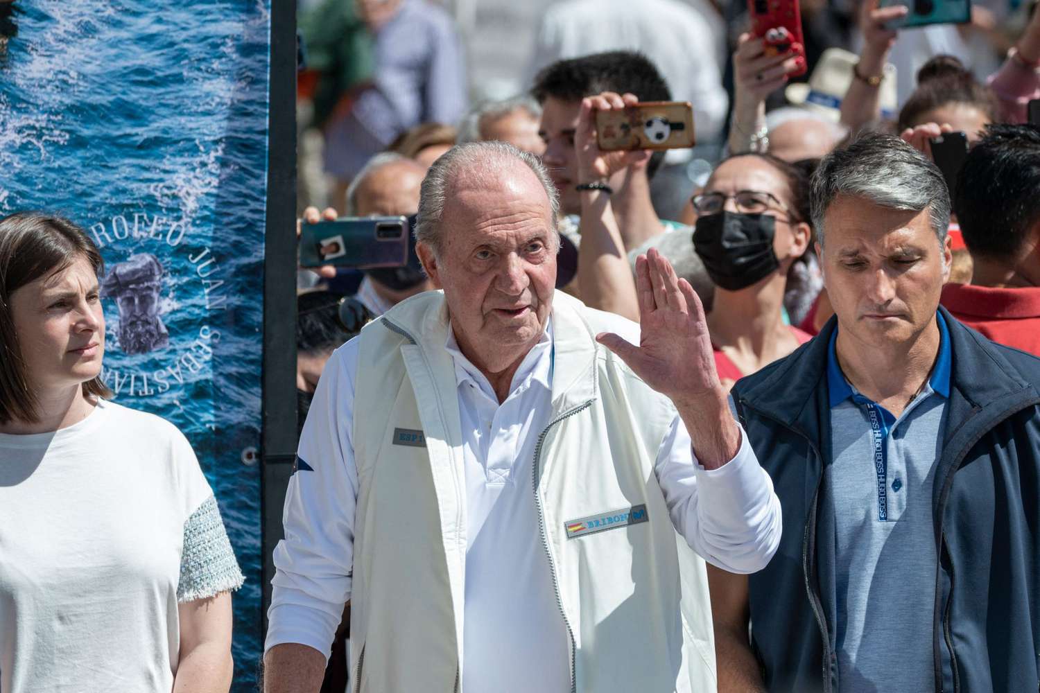 TOPSHOT - Spain's former King Juan Carlos I waves from his "Bribon" boat, as he attends the regatta of the InterRias trophy of 6M Spanish Cup, in the Galician town of Sanxenxo, northwestern Spain, on May 21, 2022. - Spain's former king returned to the country on May 19, 2022 for his first visit since he left nearly two years ago following a string of financial scandals. (Photo by Brais Lorenzo / AFP) (Photo by BRAIS LORENZO/AFP via Getty Images)