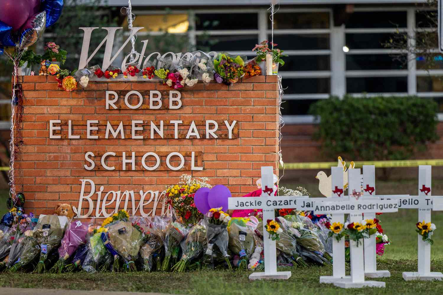 A memorial is seen surrounding the Robb Elementary School sign following the mass shooting at Robb Elementary School