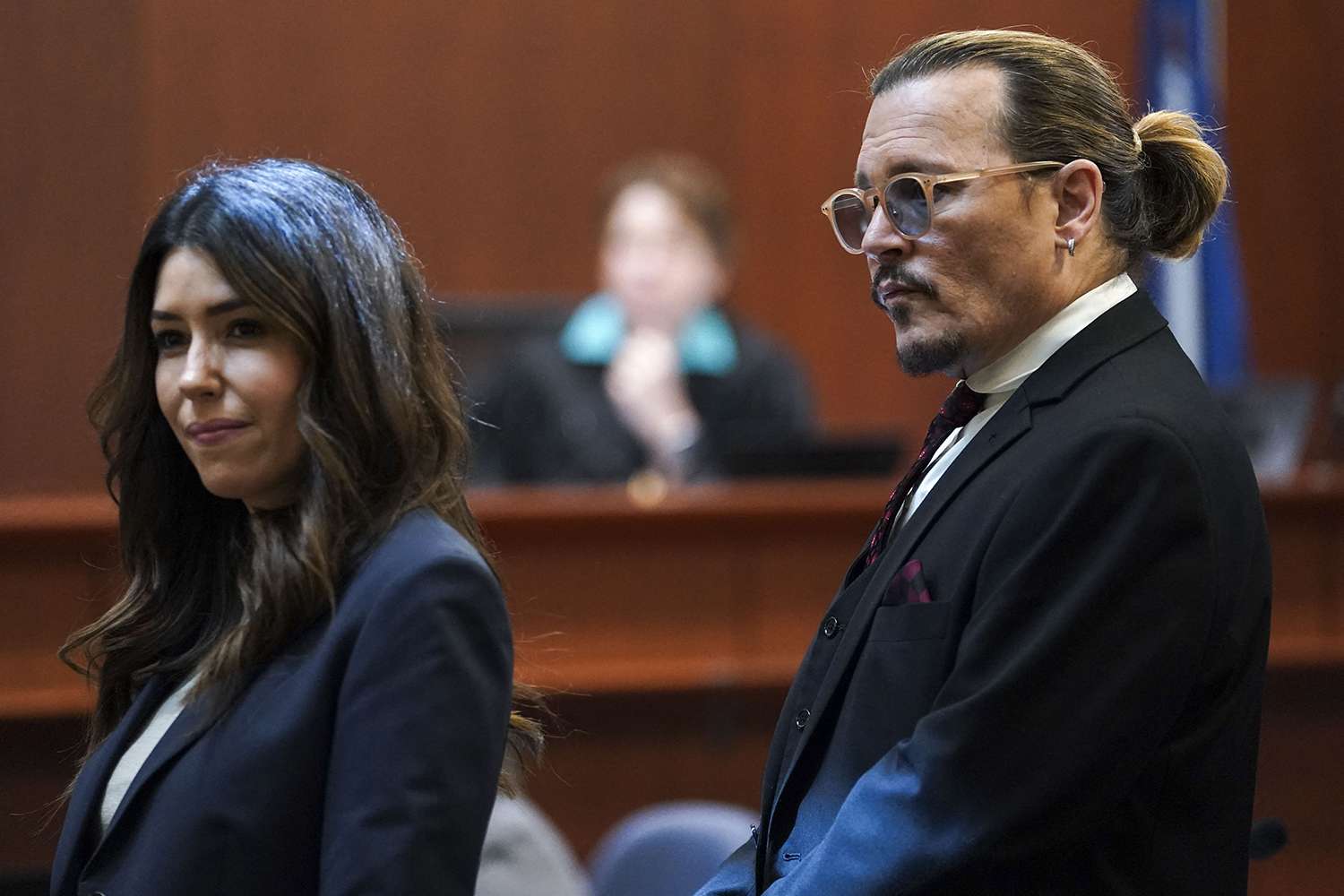 US actor Johnny Depp stands next to his lawyer Camille Vasquez after a break in the defamation trial against ex-wife Amber Heard at the Fairfax County Circuit Courthouse