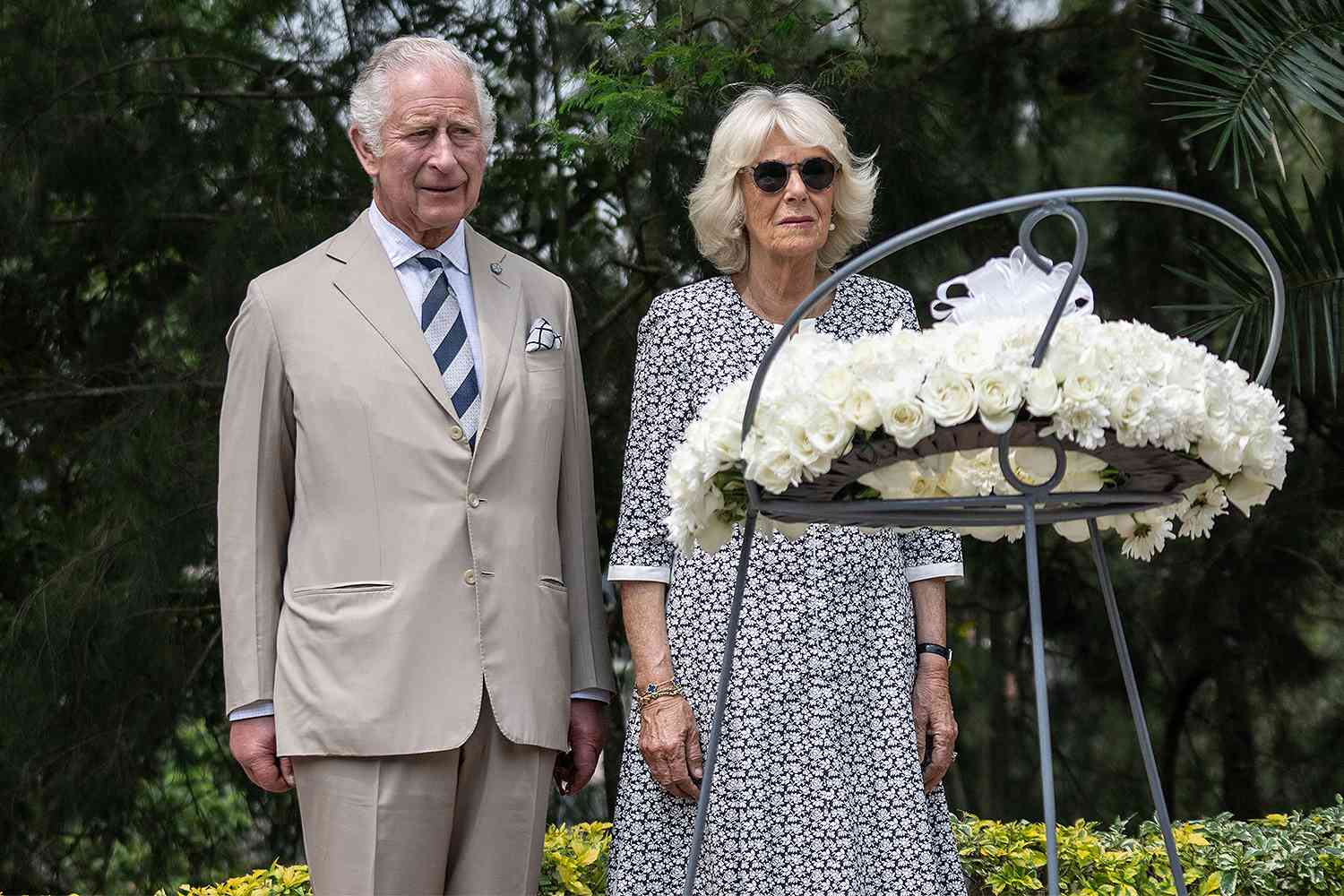 Britain's Prince Charles, Prince of Wales, and Britain's Camilla, Duchess of Cornwall pause in front of a flower wreath at the Kigali Genocide Memorial, Kigali, Rwanda on June 22, 2022 during a visit. - Britain's Prince Charles will take part in the 26th Commonwealth Heads of Government Meeting held in Kigali, Rwanda from the 20 june until the 25 June 2022.