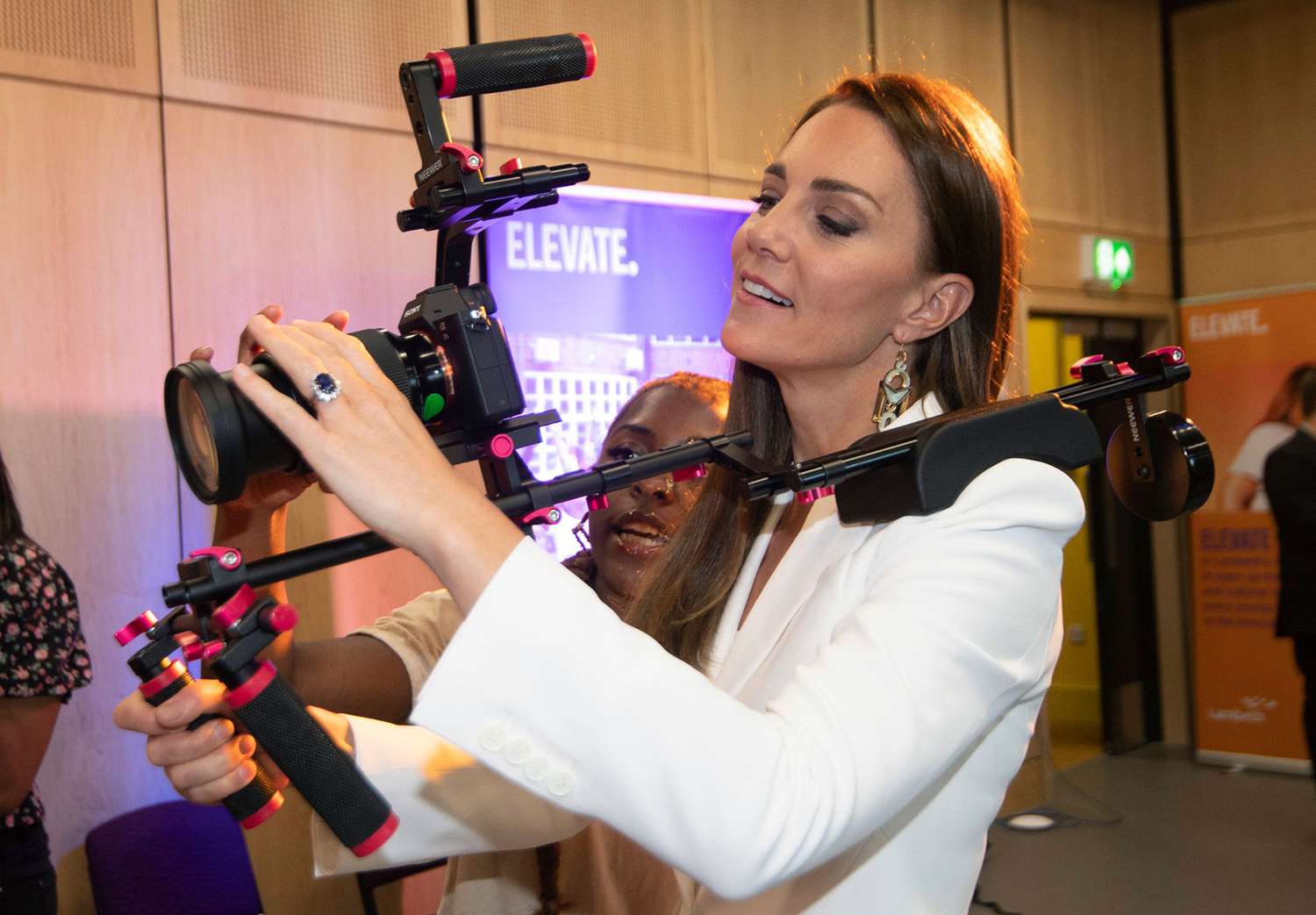 Britain's Kate, Duchess of Cambridge, holds a camera, druing a visit to ELEVATE, at Brixton House