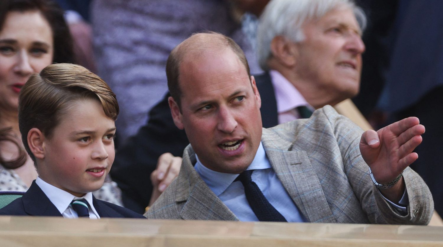 Britain's Prince William, Duke of Cambridge (R) talks to his son Prince George as they attend the men's singles final tennis match between Serbia's Novak Djokovic and Australia's Nick Kyrgios on the fourteenth day of the 2022 Wimbledon Championships at The All England Tennis Club in Wimbledon, southwest London, on July 10, 2022. - RESTRICTED TO EDITORIAL USE (Photo by Adrian DENNIS / AFP) / RESTRICTED TO EDITORIAL USE (Photo by ADRIAN DENNIS/AFP via Getty Images)