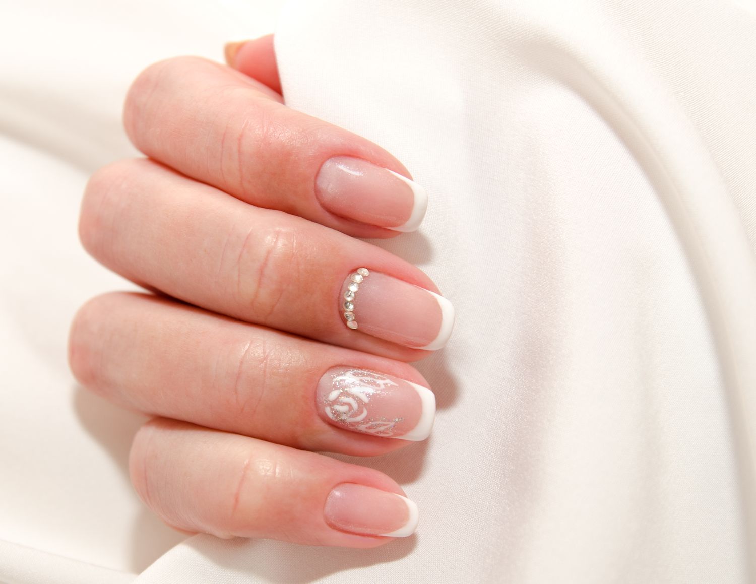 Woman's nails with beautiful french manicure fashion design