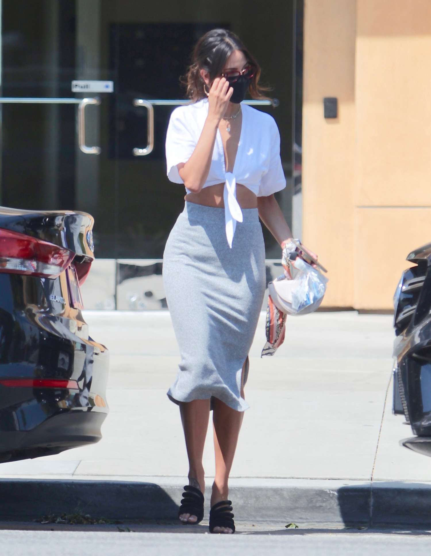 Eiza Gonzalez steps out in a grey pencil skirt and white buttoned down top for a lunch meeting. Eiza was also seen wearing prescription glasses. 18 Aug 2020 Pictured: Eiza Gonzalez steps out in a grey pencil skirt and white buttoned down top for a lunch meeting.