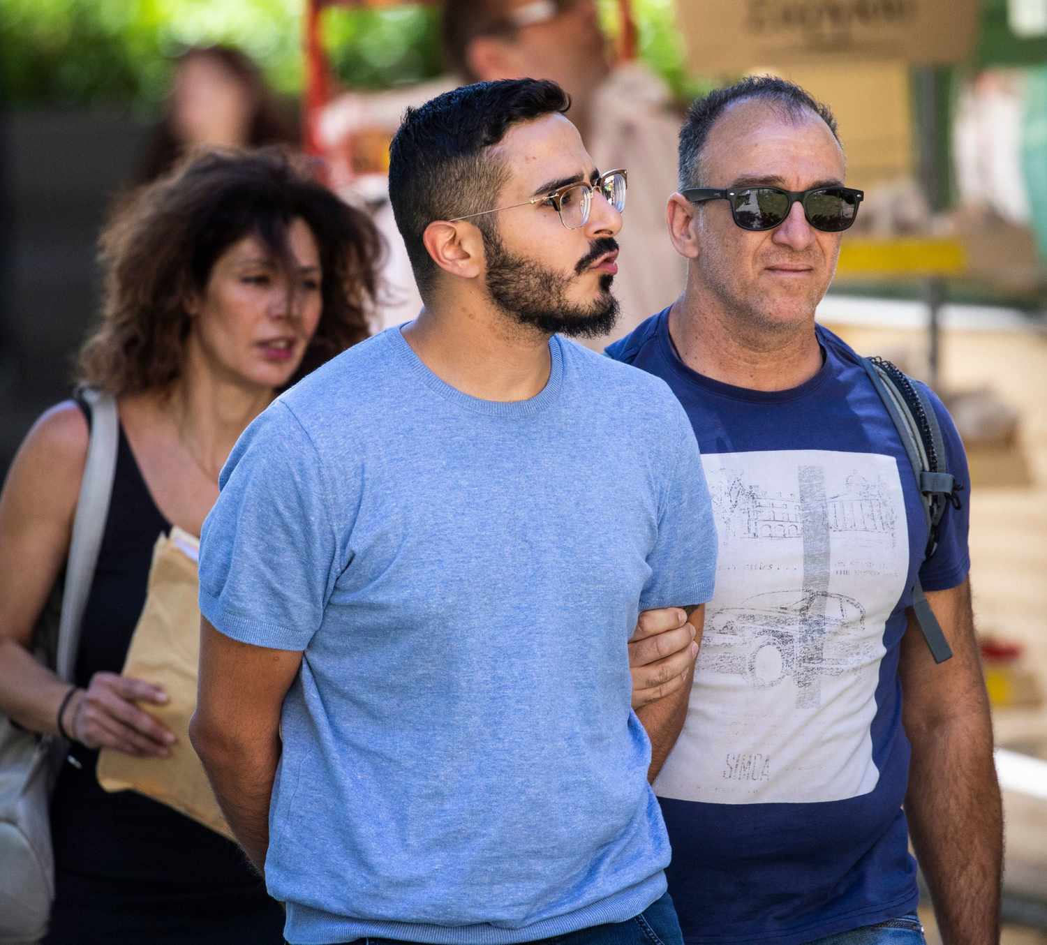 Picture taken on July 1, 2019 shows the so-called "Tinder swindler" (L) as he is expelled from the city of Athens, Greece. -