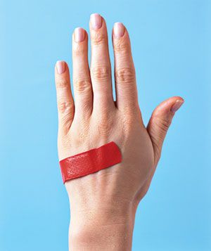 Red band aid on a hand