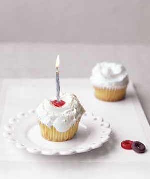 Cupcake with a candle held by a LifeSaver