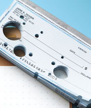 Checkbook with punched-out holes