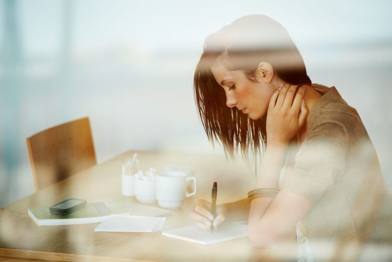 Woman writing journal coffee
