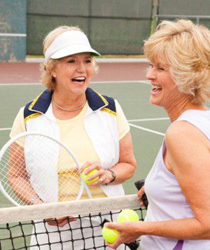 Women talking on a tennis court