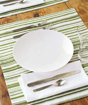 A generously sized place mat in a graphic pattern serves up visual interest in a minimal arrangement.
