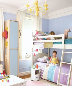 Two girls on bunk beds in an organized clean children's room