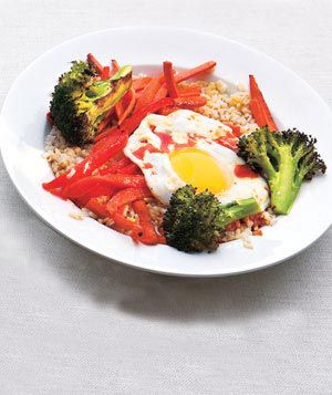 Asian Rice and Vegetable Bowl With Eggs and Chili Sauce 