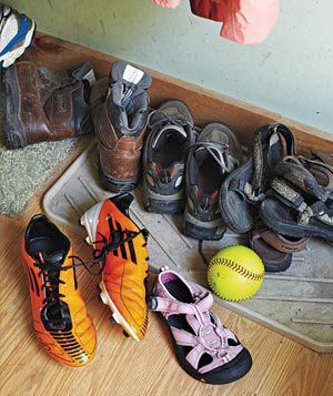 Shoes scattered throughout messy mudroom