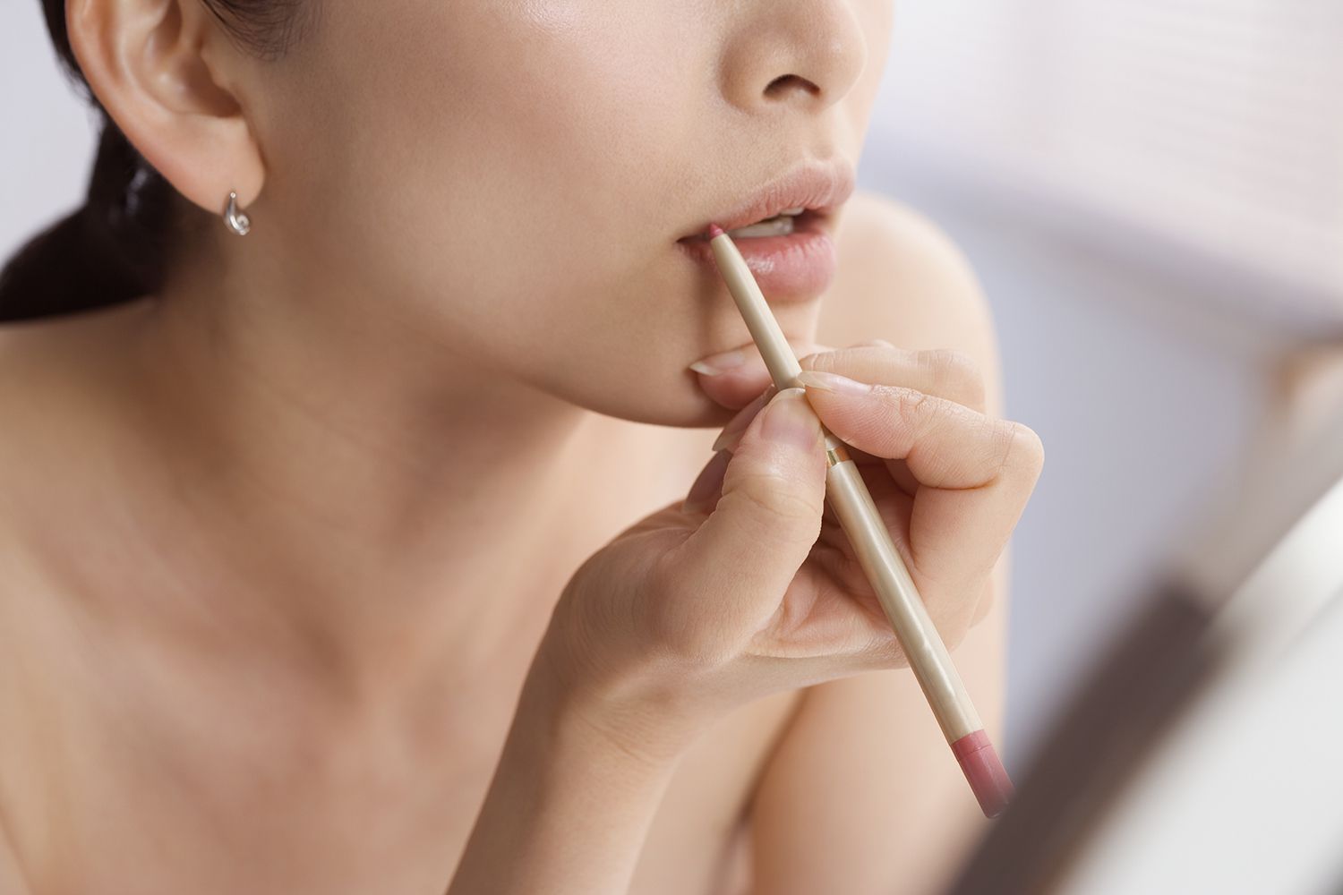 Woman applying lip liner