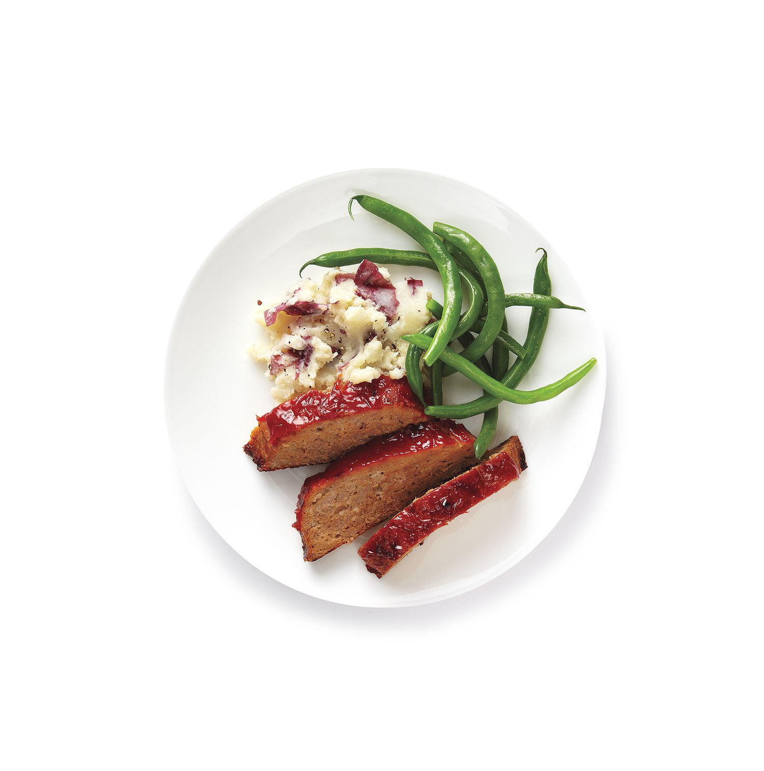 Turkey meat loaf with mashed potatoes and green beans served on a plate.
