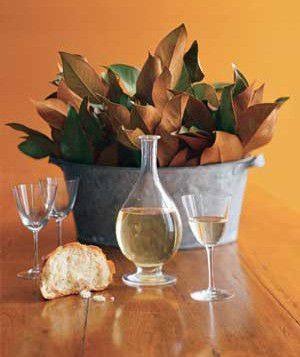 Centerpiece made of leaves on a table with bread and wine