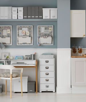 Gray and white home office space adjacent to kitchen