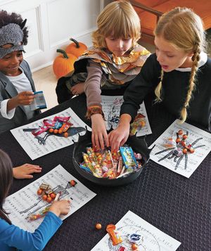Kids at Halloween table with candy
