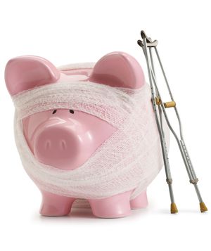 Piggy bank with bandages and crutches