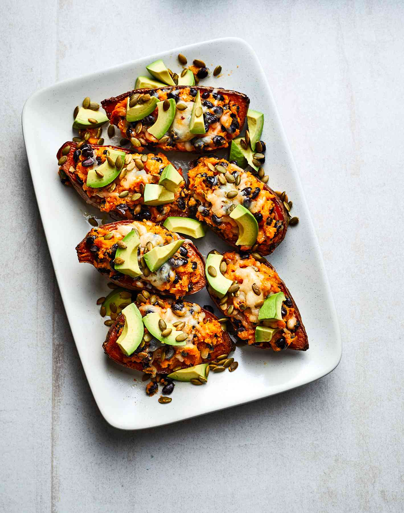 Cheesy Twice-Baked Sweet Potatoes With Black Beans and Avocado