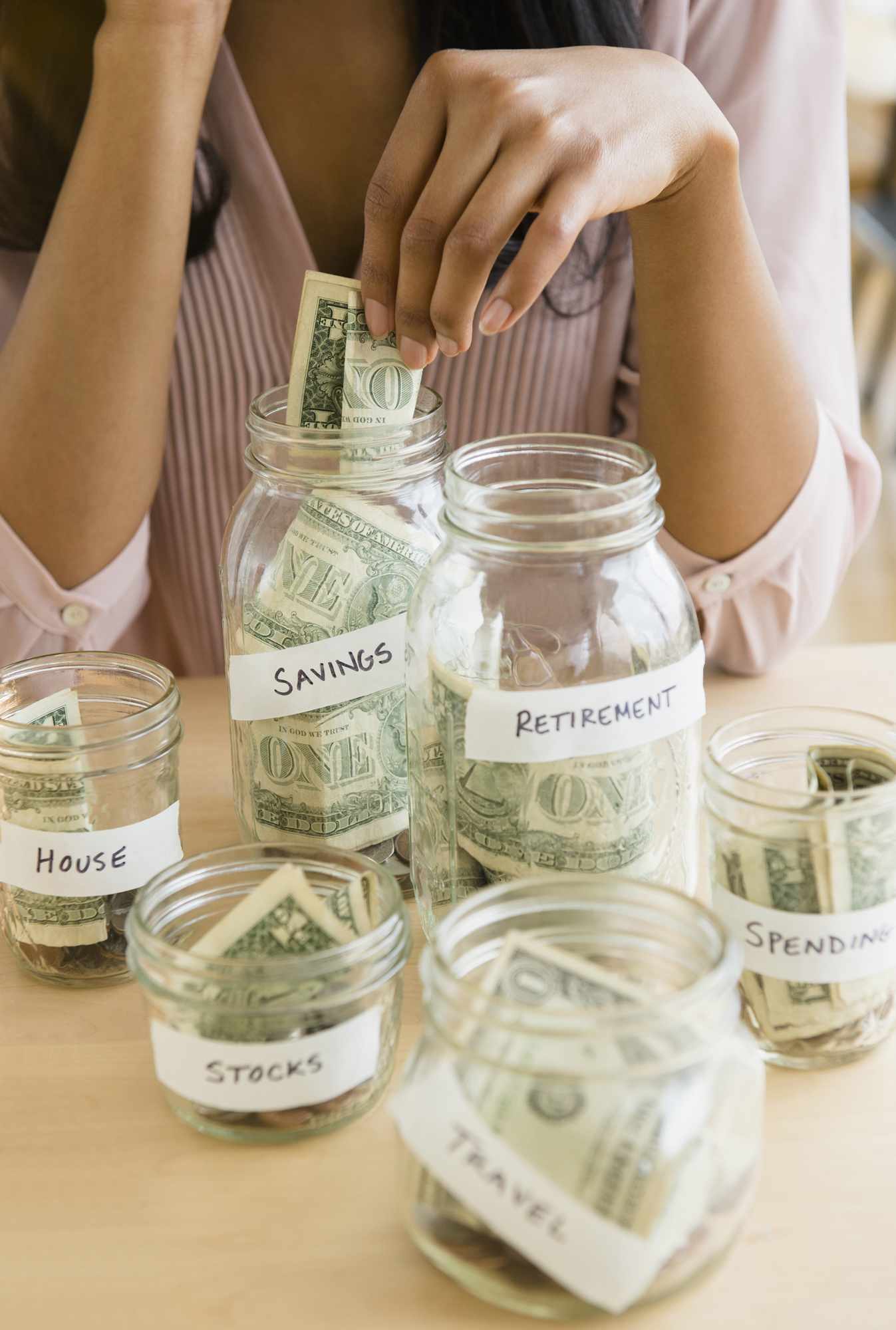 Money separated in jars for saving