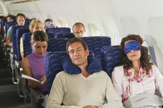 People Sleeping on a Plane to Prevent Jet Lag Symptoms