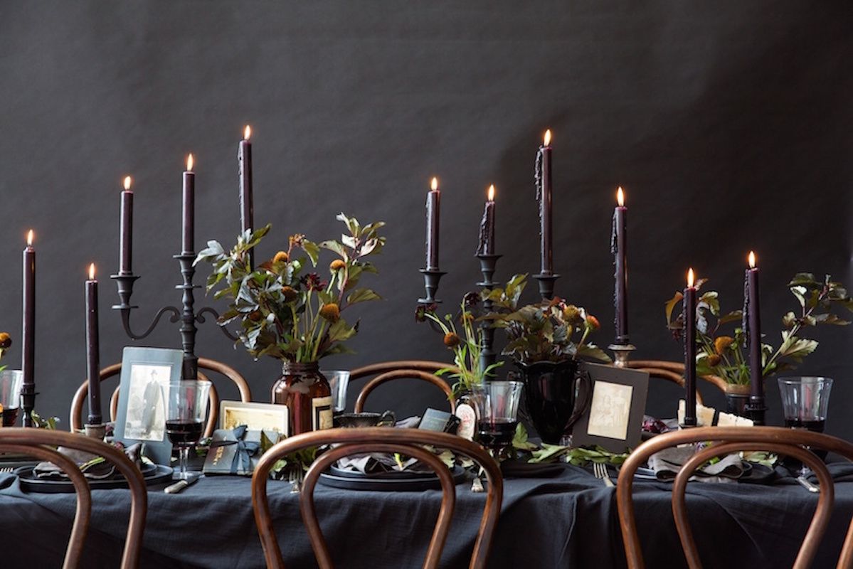 Halloween dinner party with black candles and flowers