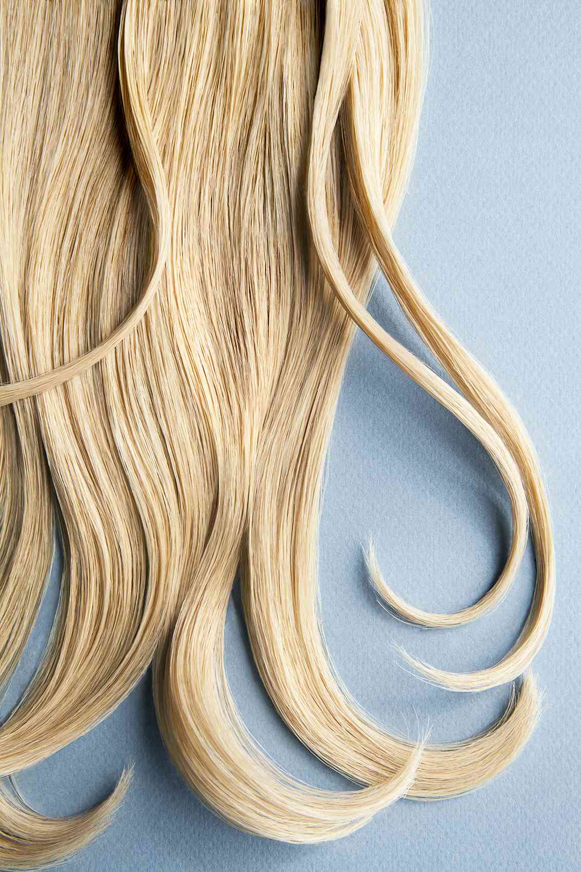 Blond hair on blue background
