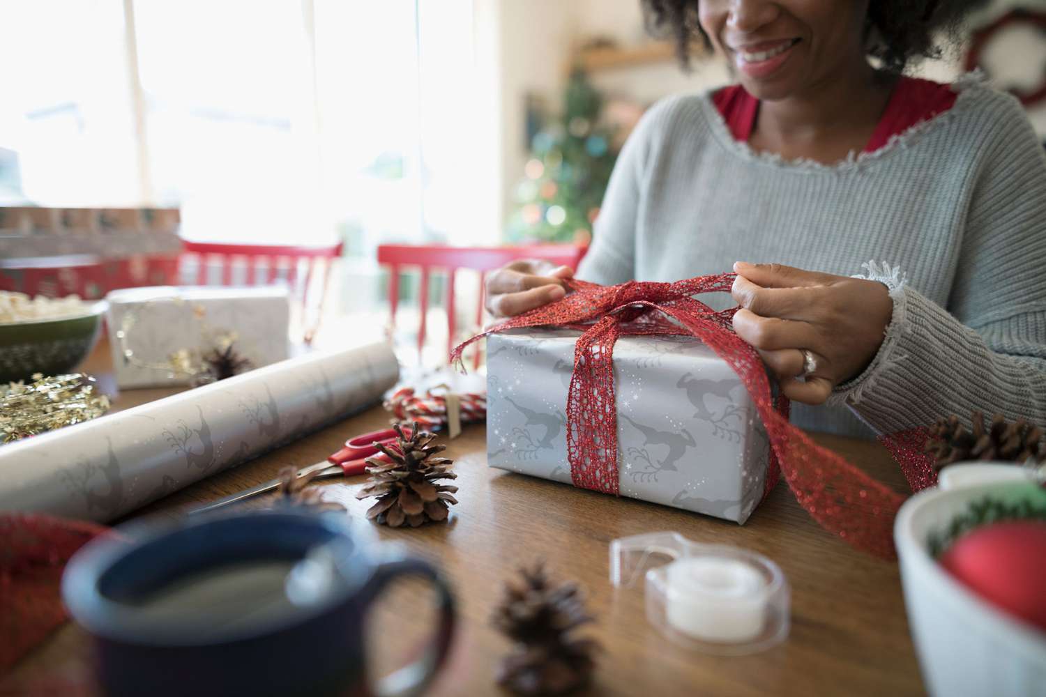 Woman wrapping gifts - gift wrapping mistakes