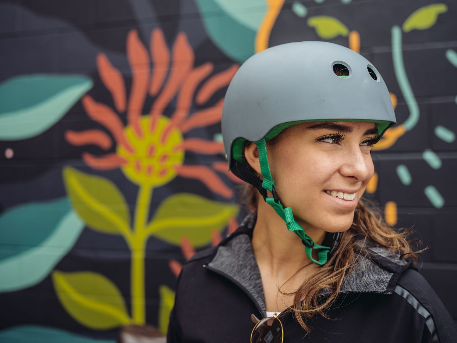 Woman wearing a bike helmet: bike helmet fit, and more bike helmet safety tips