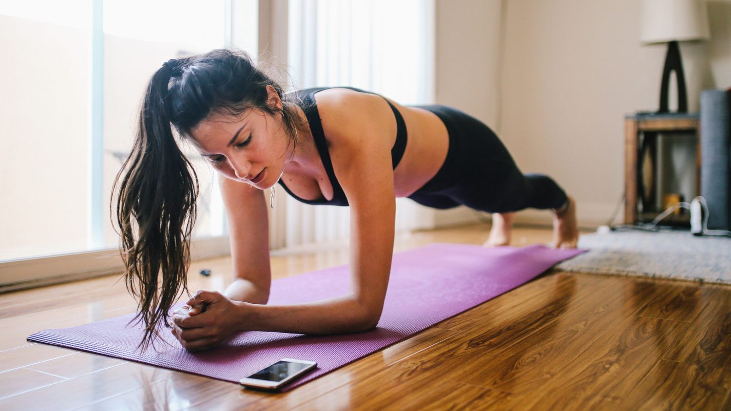 Woman exercising planks at home in Los Angeles
