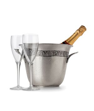 champagne in metal ice bucket and glasses