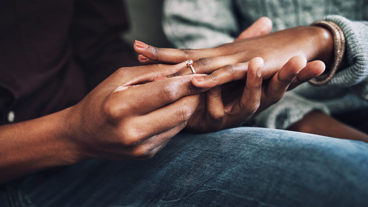 Most popular dates to get engaged December 2020: Man putting ring onto finger of girlfriend closeup hand shot