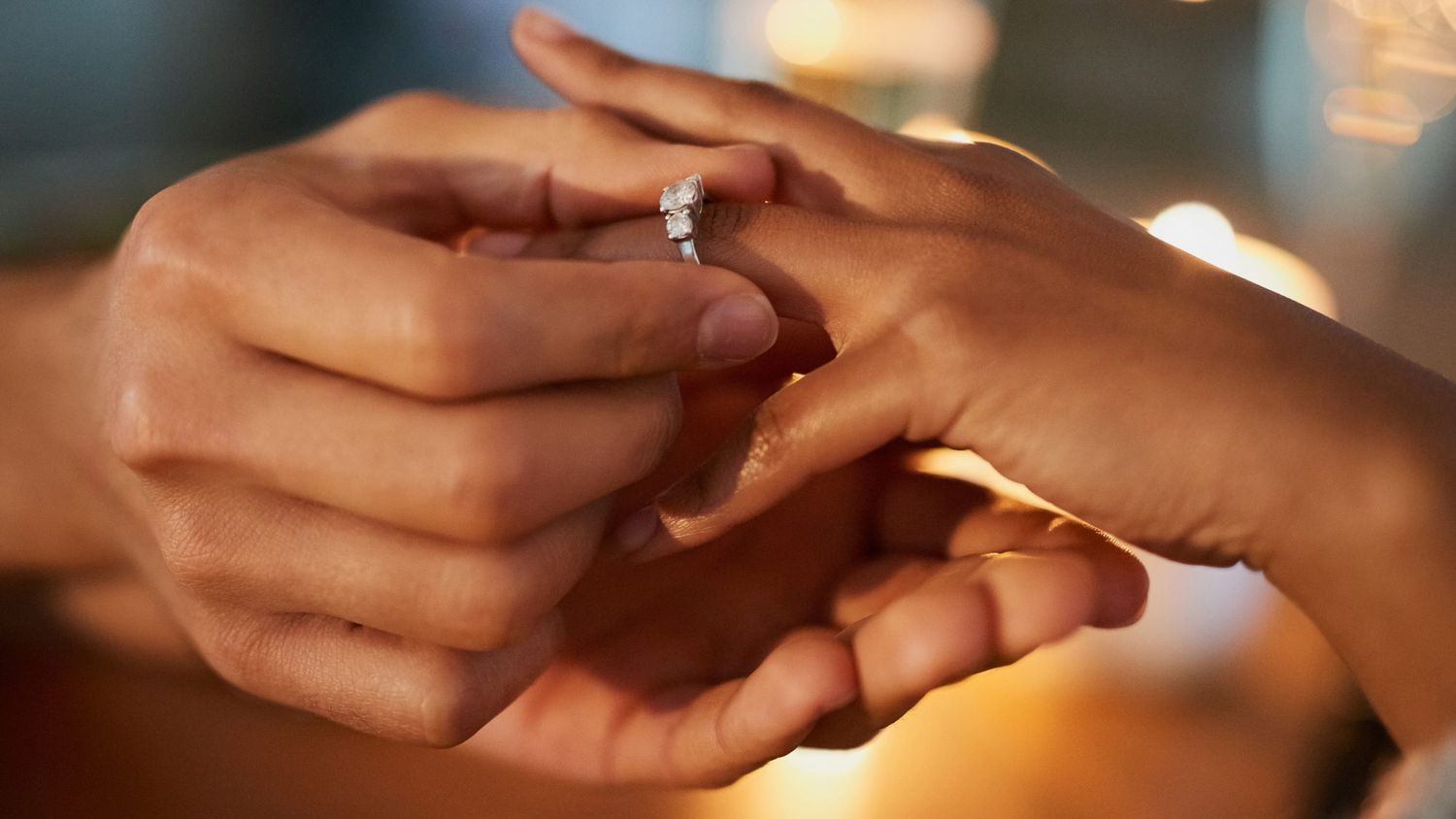 Engagement Ring Trends for 2021: someone putting diamond engagement ring on partner