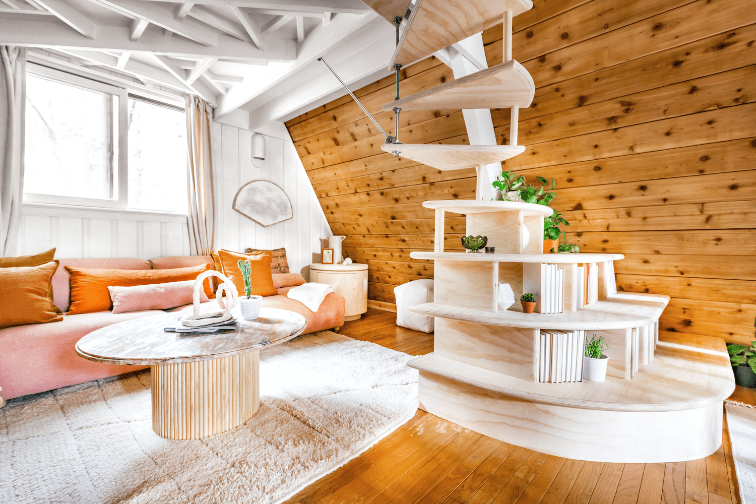 living room with wood and white walls, blush sofa