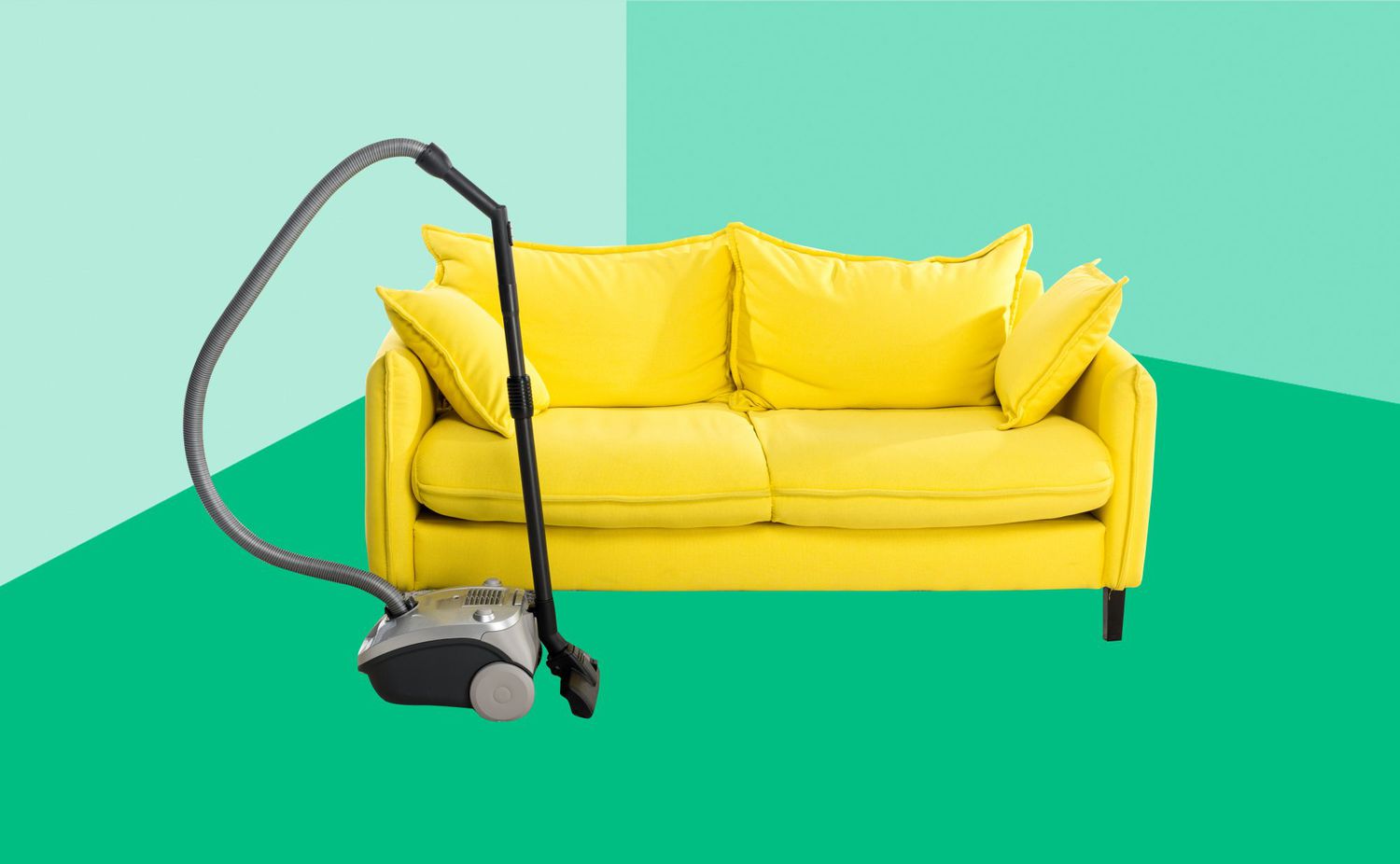 bright yellow sofa and vacuum cleaner on carpet isolated on white
