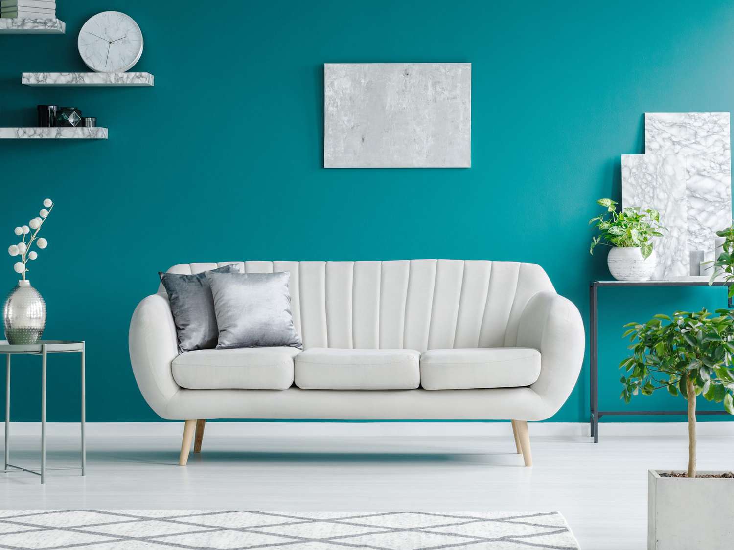White sofa against teal wall