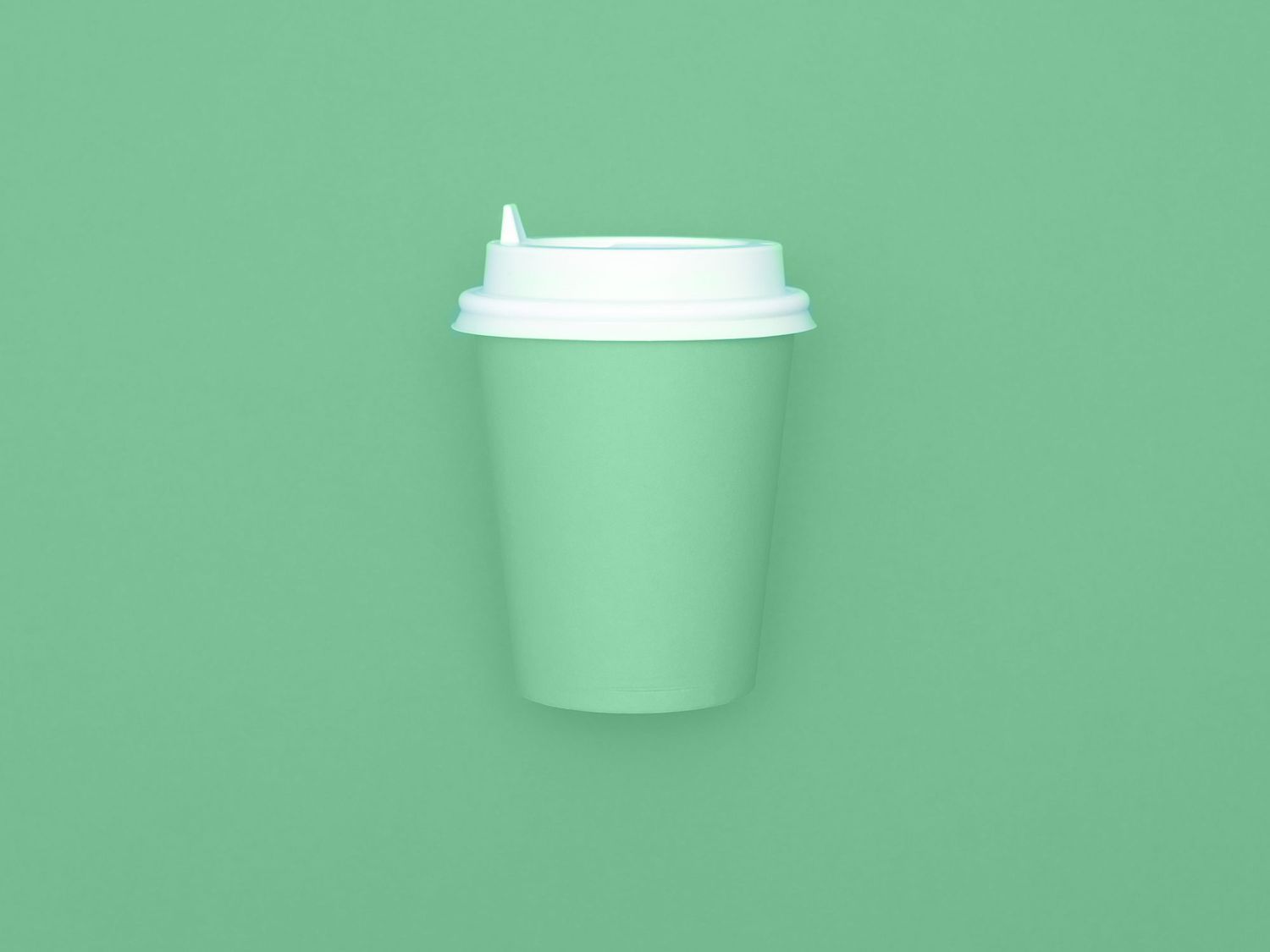 Reusable eco friendly bamboo cup for take away coffee on mint background. Space for text. Flat lay, top view. Bring your own cup concept. Zero waste, sustainable lifestyle.